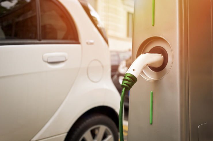 Electric vehicle plugged into a charging station