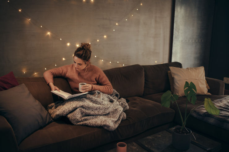 Woman reading on couch | Contents Insurance | An Post Insurance